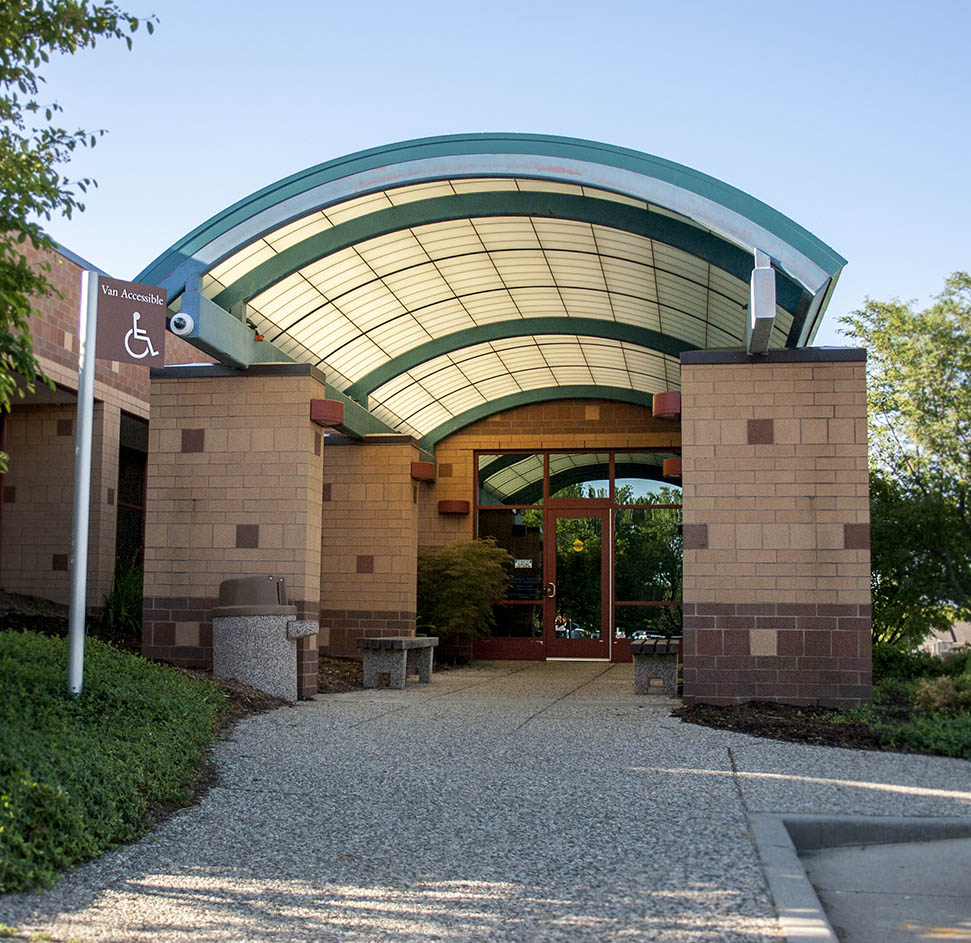 Holland BPW Service Center entrance: a brown building with and arched roof over a walkway