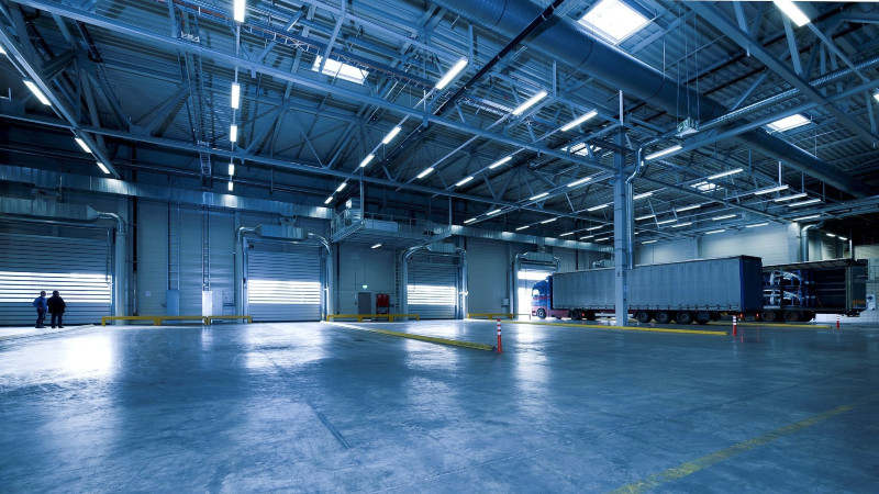 Inside an industrial building logistics bay with one semi truck pulled in