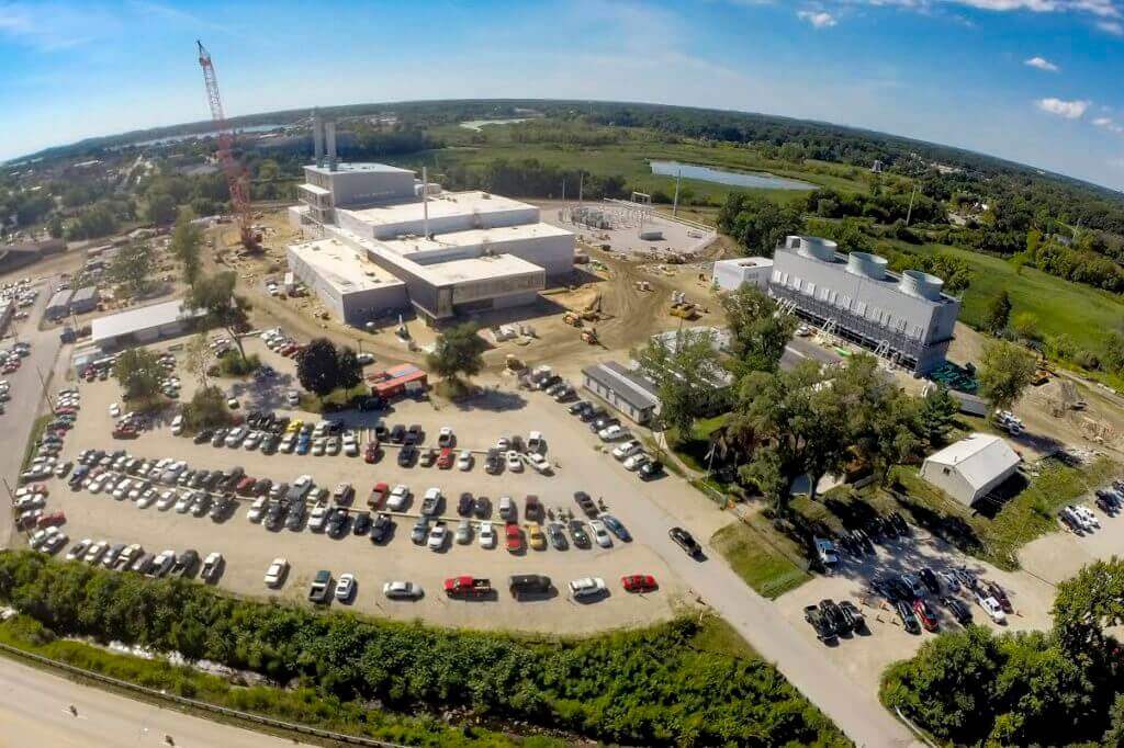 Satellite image of Holland Energy Park as it is being built with cranes and many cars in the parking lot.