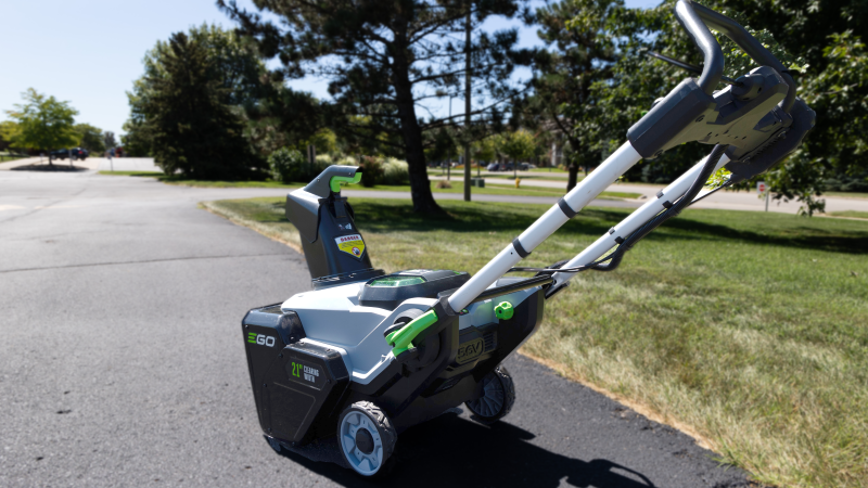 An EGO snowblower sits in a parking lot