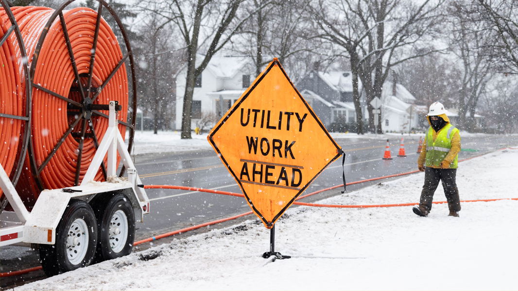 a truckload of orange fiber conduit, a sign that says 