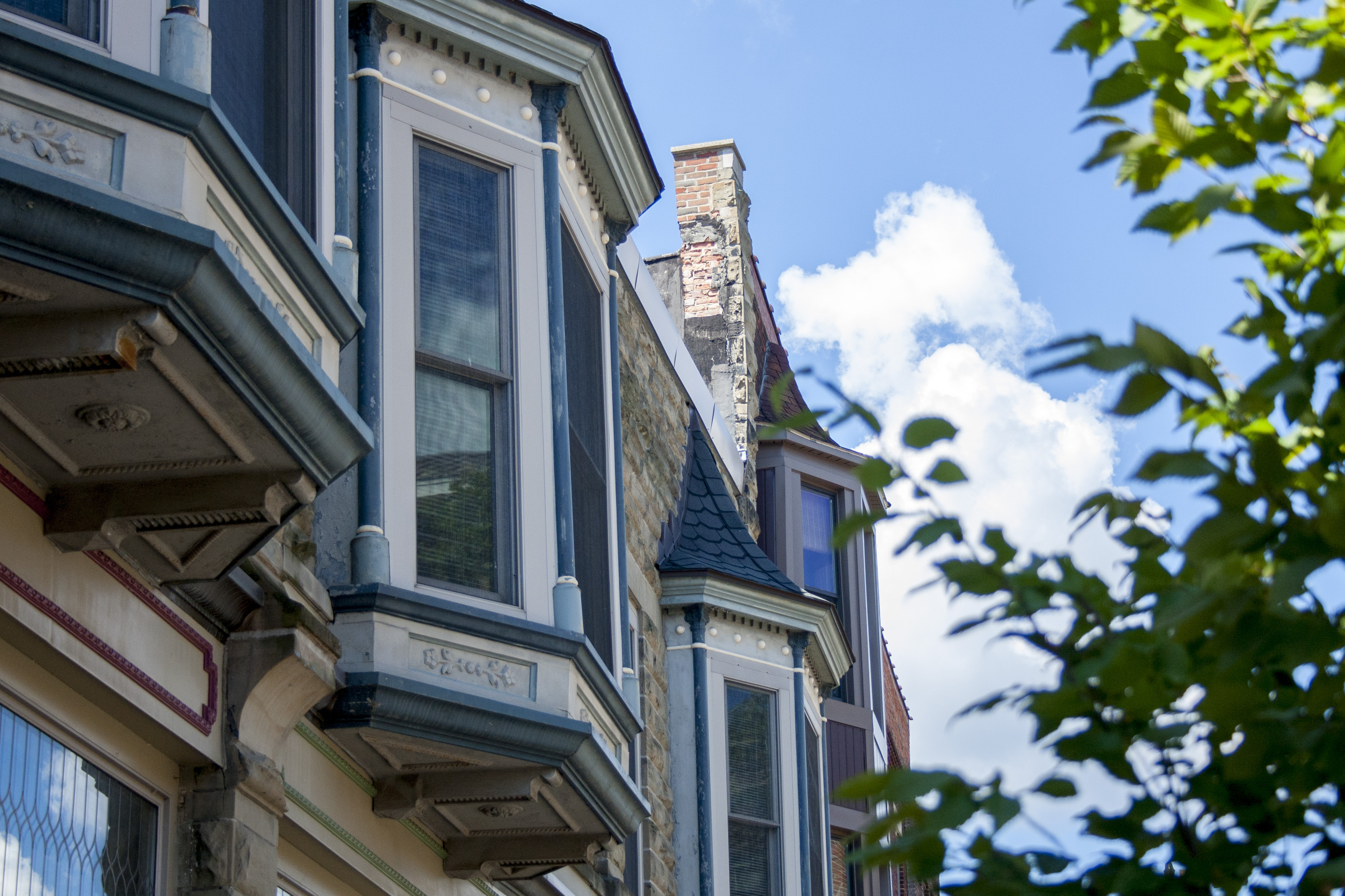 A row of windows from the facade of upper apartments in downtown Holland