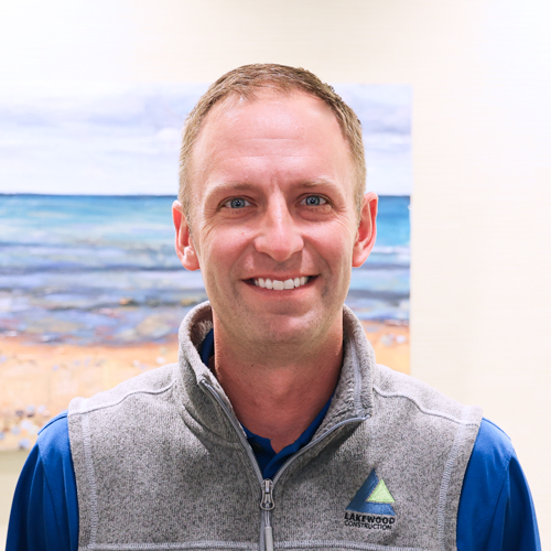Male executive wearing a blue shirt and a grey vest
